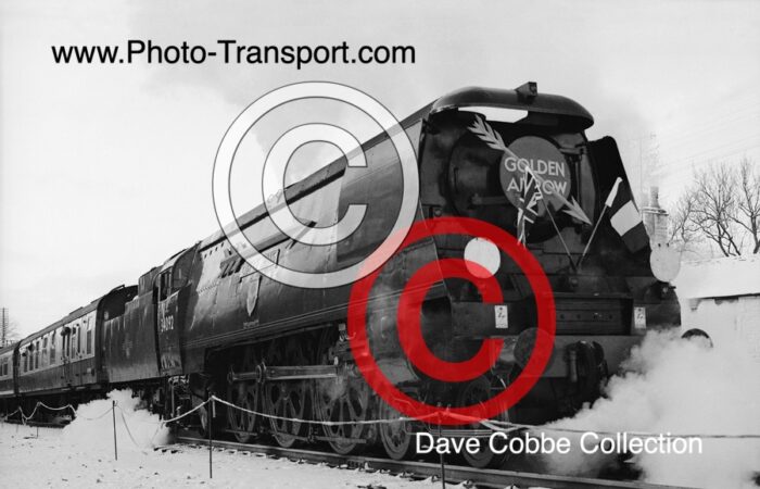 West Country Unrebuilt 4-6-2 No.34092 City of Wells on a cold winters snowy day at  unknown location / date  and has the full Golden Arrow Headboard and Arrow on side of loco 